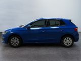 the blue car is parked on the concrete floor in the room