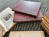 several old books are stacked on top of each other on a carpet