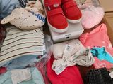 a box full of baby clothes and a pair of shoes
