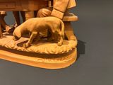 a statue of a man and a dog on a bench