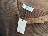 a close up of a sweater with a tag on it