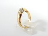 a close up of a gold ring with a diamond on it