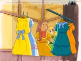 three dresses hanging on a clothes rack in a window