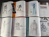 a lot of books that are open on a table