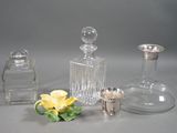 three glass vases and a silver vase on a table