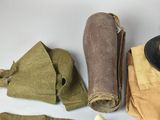 a hat, scarf, gloves, and other items that are on a table