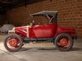 a red car parked in a garage with a brick wall behind it