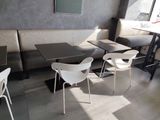 tables and chairs in a restaurant with a black and white checkered floor