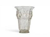 a glass vase that is sitting on a white surface