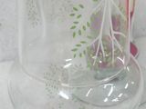 a glass vase with a flower in it on a table