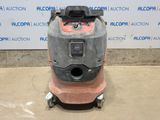 a close up of a floor scruber on a concrete surface