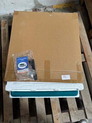 a laptop computer sitting on a pallet in a room
