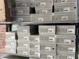 a lot of boxes that are stacked up on a shelf
