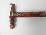 an old wooden hammer with a wooden handle on a white surface