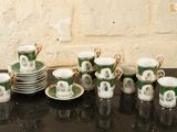 a lot of cups and saucers on the table