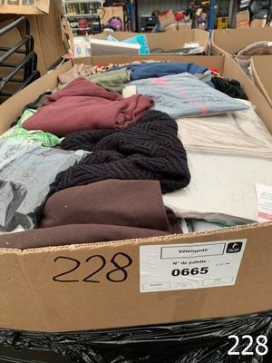 a cardboard box filled with lots of clothes in a store