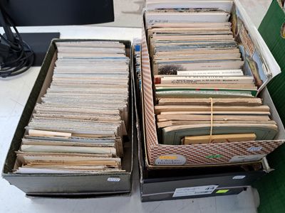 two boxes full of books sitting on a table