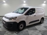 the white van is parked on a checkered tile floor