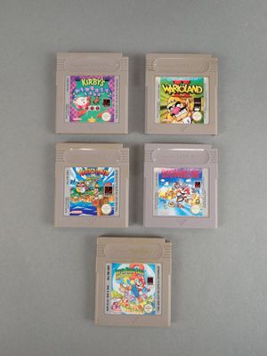four nintendo game cartridges sitting on top of a table next to each other