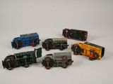 several toy trains are lined up in a row on a white surface