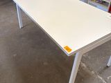 an image of a white table with a yellow tag on it