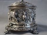 a silver box that has a deer design on it
