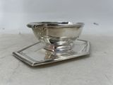 a silver plate with a bowl on top of it