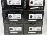 four boxes of black electronic devices are stacked on top of each other