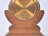 a gold plate on a wooden stand on a white background