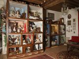 a room with a lot of dolls on display in it