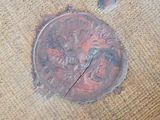 a picture of a piece of wood with a rusted metal cover on it