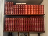 many books that are on the shelves in the room
