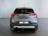 the rear end of a silver car in a white room