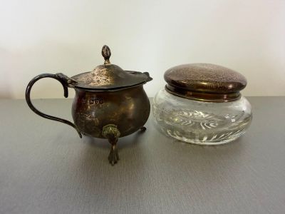 a small glass jar with a metal lid next to a small glass jar with a metal lid