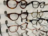 many glasses that are on a wall in a store