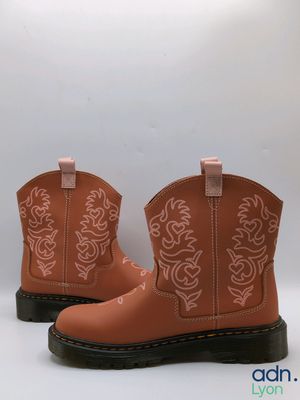 a close up of a pair of children ' s boots on a white background