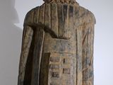 a wooden statue of a man with a helmet on