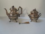 pair of antique silver teapots with handles and spoons