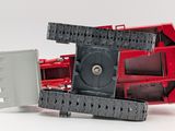 a red and black toy tractor with a box on the back of it