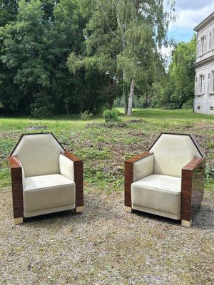 pair of art deco lounge chairs in the style of a pair of armchairs