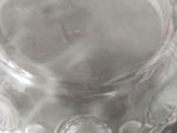 a clear glass jar with a flower design on it