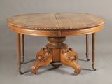 an oval dining table with two leaves on the top and two leaves on the base