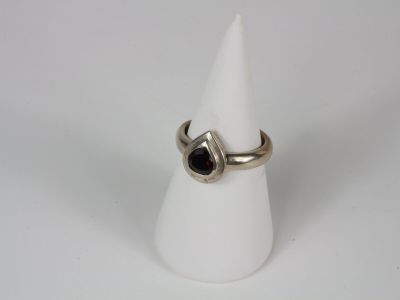 a close up of a ring on a white cone on a white surface