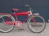 a red bicycle that is parked in front of a building