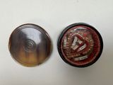 two tins that are sitting next to each other on a table