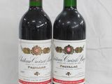two bottles of wine sitting next to each other on a table