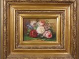 a painting of flowers in a gold frame on a green surface