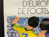 a poster of a couple of soccer players on the wall
