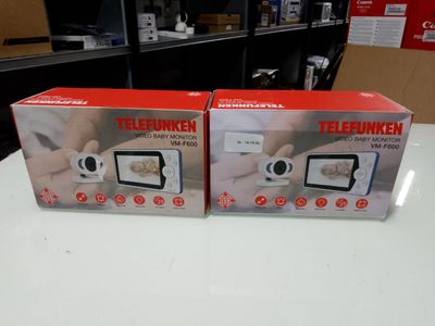 two boxed nintendo wii game consoles sitting on top of a white table