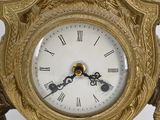 a gold clock that is sitting on a table